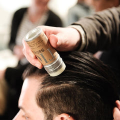 TIGI Bed Head wax stick semi-matte finish highlighting defined texture.