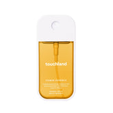 Touchland Mango Mojo bottle pour shows quick, refreshing spritz for skin and hair.