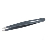 Tweezerman stainless steel slant tweezer with blue stone for precise brow shaping.