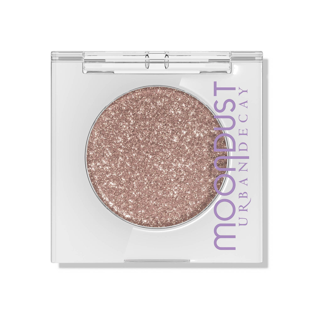 Urban Decay Moondust Space Cowboy swatch shows champagne gold sparkle on the eyelid.