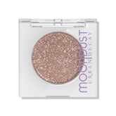 Urban Decay Moondust Space Cowboy swatch shows champagne gold sparkle on the eyelid.