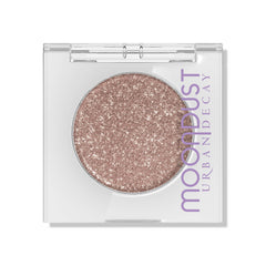 Urban Decay Moondust Space Cowboy swatch shows champagne gold sparkle on the eyelid.