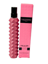 Valentino Donna Born in Roma Intense travel spray bottle front view for on-the-go scent.