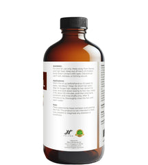 Velona Jojoba Oil application drops on fingertip for moisturizing routine.