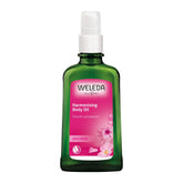 Weleda Aceite corporal rosa salvaje en botella dosificador para hidratación suave.