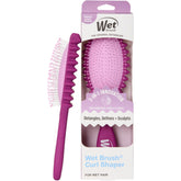 Wet Brush Curl Shaper in hand detangles wet curls gently for smooth styling.