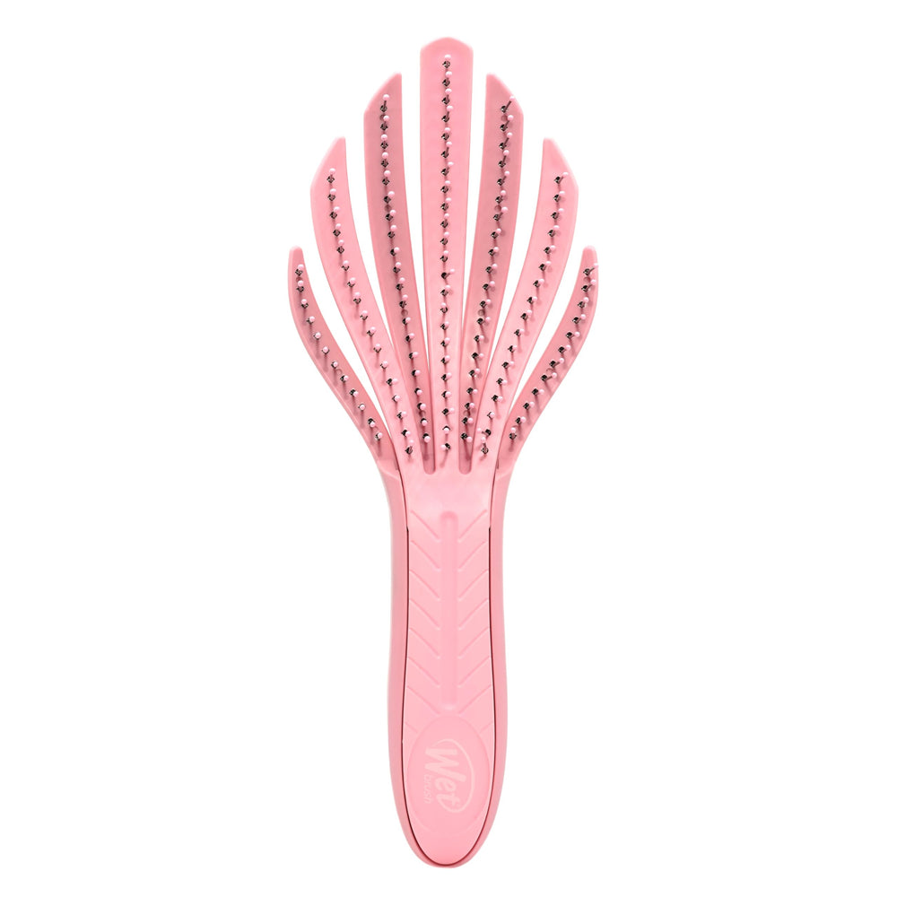 Wet Brush Go Green Curl Detangler in pale pink glides through curls for painless detangling.