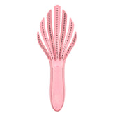 Wet Brush Go Green Curl Detangler in pale pink glides through curls for painless detangling.