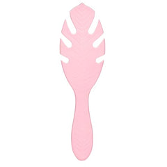 Close-up of IntelliFlex bristles gliding through tangles on pink Go Green brush