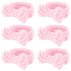 WHAVEL banda spa rosa con lazo para mantener el cabello durante la limpieza facial.