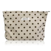 Wudygirl makeup bag in beige polka dot with corduroy texture for travel organization.