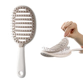 Xinqirity self-cleaning hair brush pad removal for quick cleanup after styling.