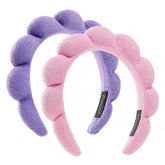 Diadema Ztomine Spa croissant rosado para mantener el cabello fuera del rostro durante la limpieza.