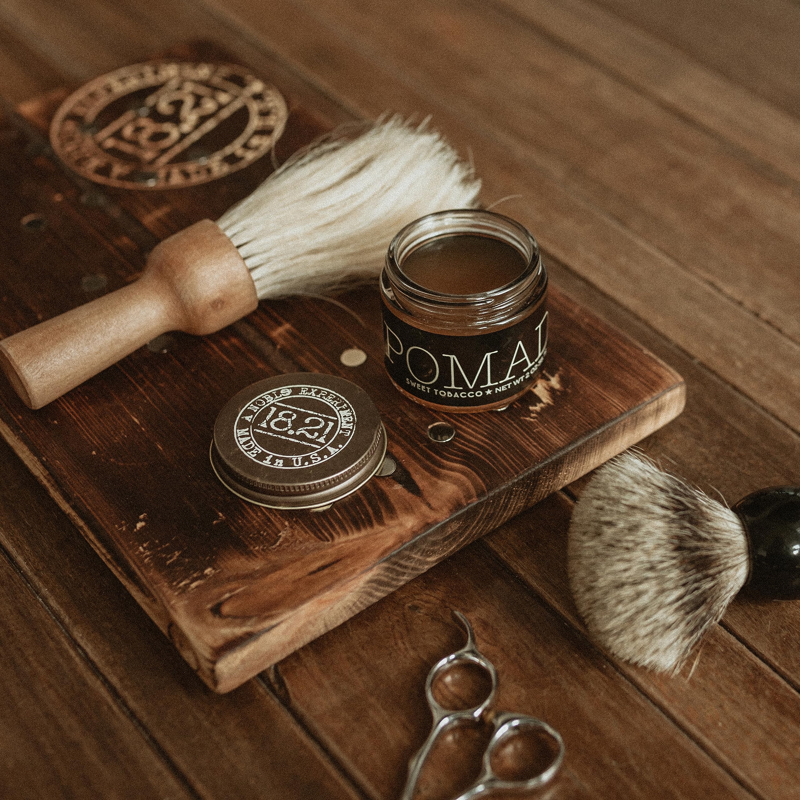 Styling short hair using 18.21 Man Made pomade for a sleek look