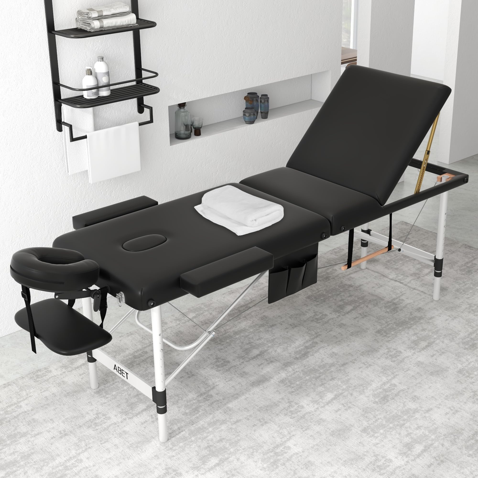 ABET massage table with height-adjustable legs for ergonomic comfort during treatments.