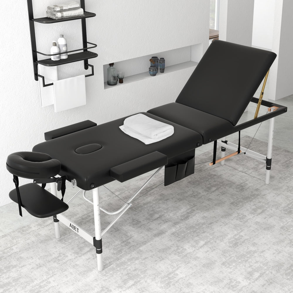 ABET massage table with height-adjustable legs for ergonomic comfort during treatments.
