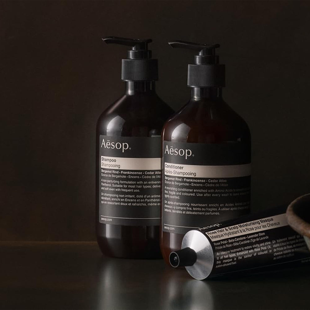 Aesop conditioner packaging closeup highlights recycled bottle and vegan formula.