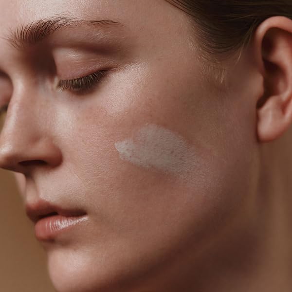 Aesop Mandarin Facial Hydrating Cream application shot, massaged into cleansed skin.