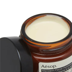 Aesop Mandarin Facial Hydrating Cream ingredients highlighted by mandarin rind and lemon rind.