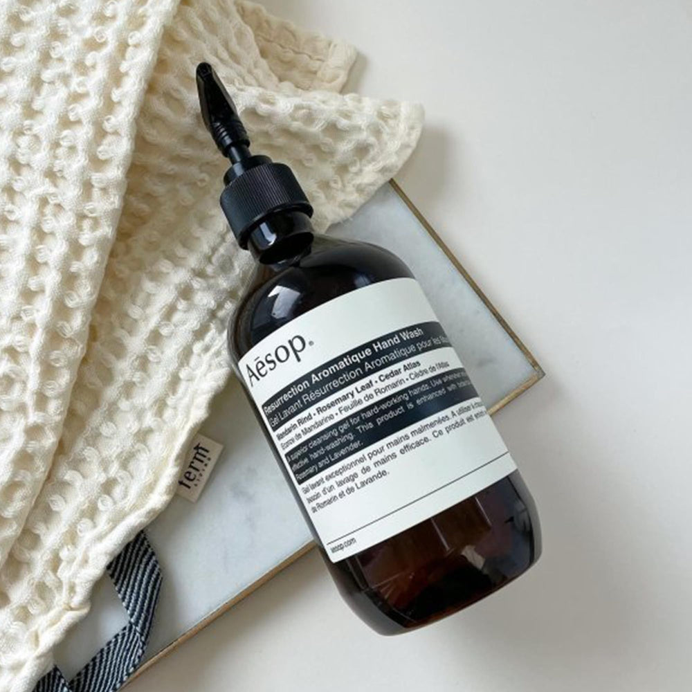Aesop Resurrection bottle close-up highlights recycled plastics and sustainable packaging.