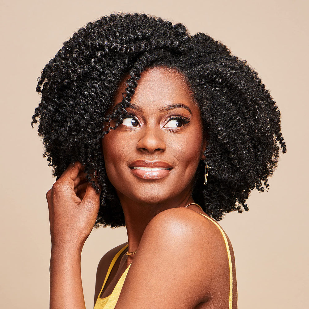 African Pride Moisture Miracle Leave-In application smoothing; helps tame frizz for easy styling