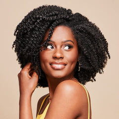 African Pride Moisture Miracle Leave-In application smoothing; helps tame frizz for easy styling