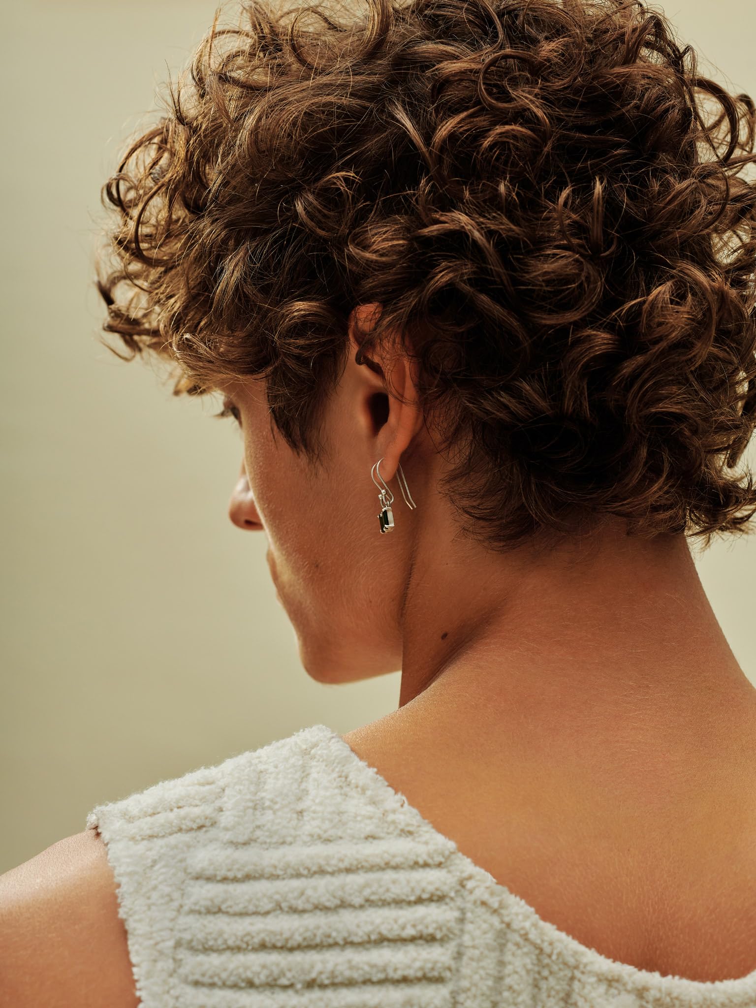 AG Care Beach Bomb applying to hair for defined waves.