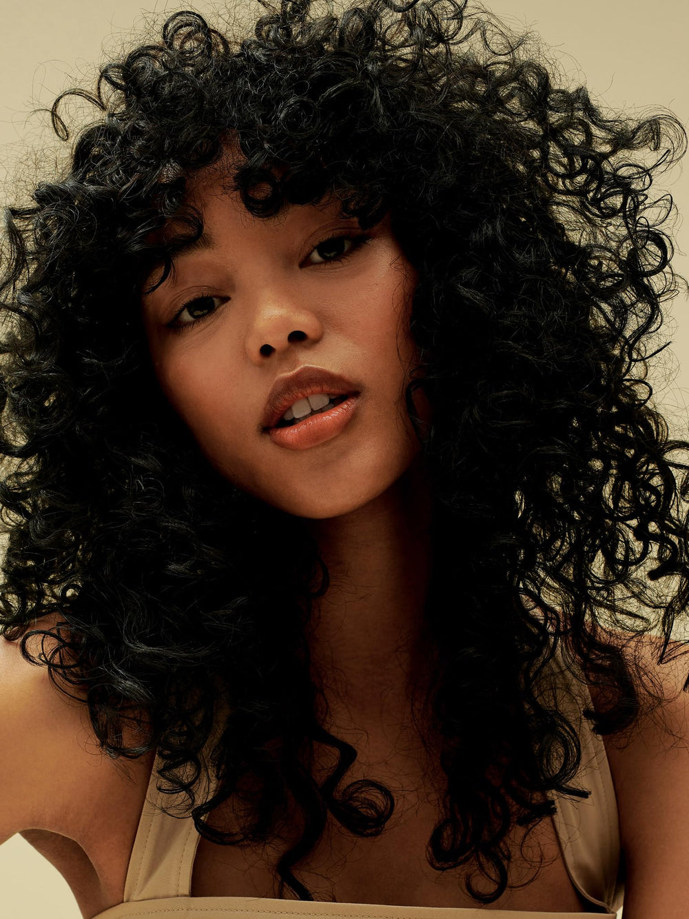 AG Care Curl Fresh Shampoo foam on hair suggests soft, manageable curls.