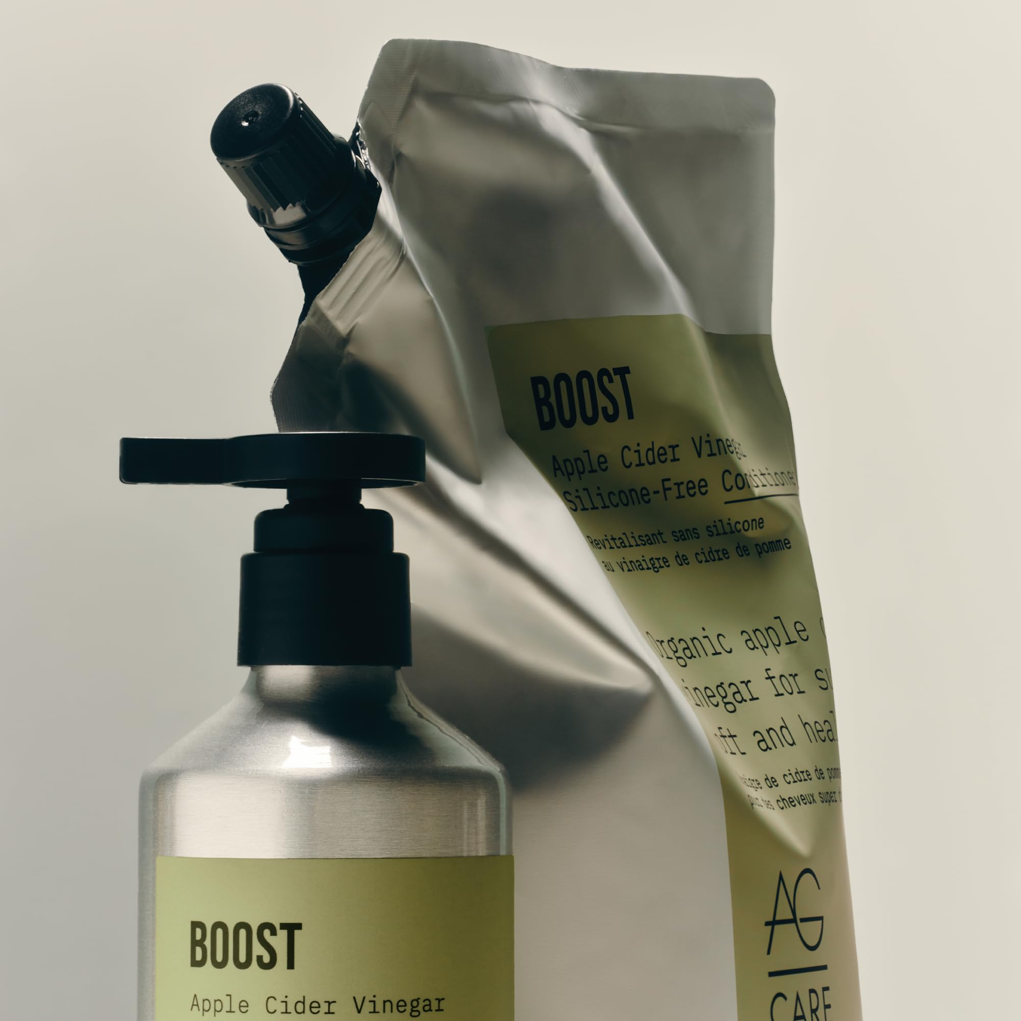 AG Care bottle beside hand for size comparison and travel-friendly impression