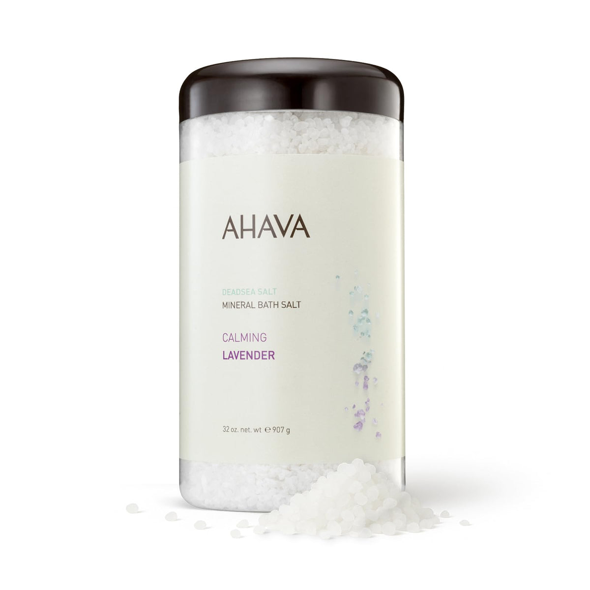AHAVA Dead Sea bath salt jar releasing calming lavender for soothing ritual.