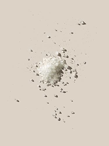 AHAVA Dead Sea bath salt pouring into warm water to ease tension.