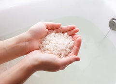 AHAVA Dead Sea mineral bath salt dissolving to soften skin and hydrate.