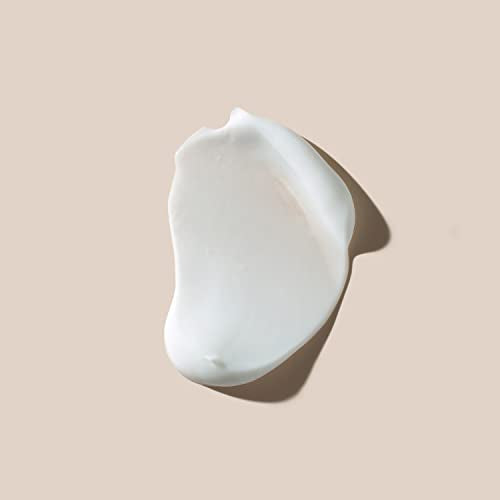 Close-up of AHAVA hand cream texture showing silky absorption
