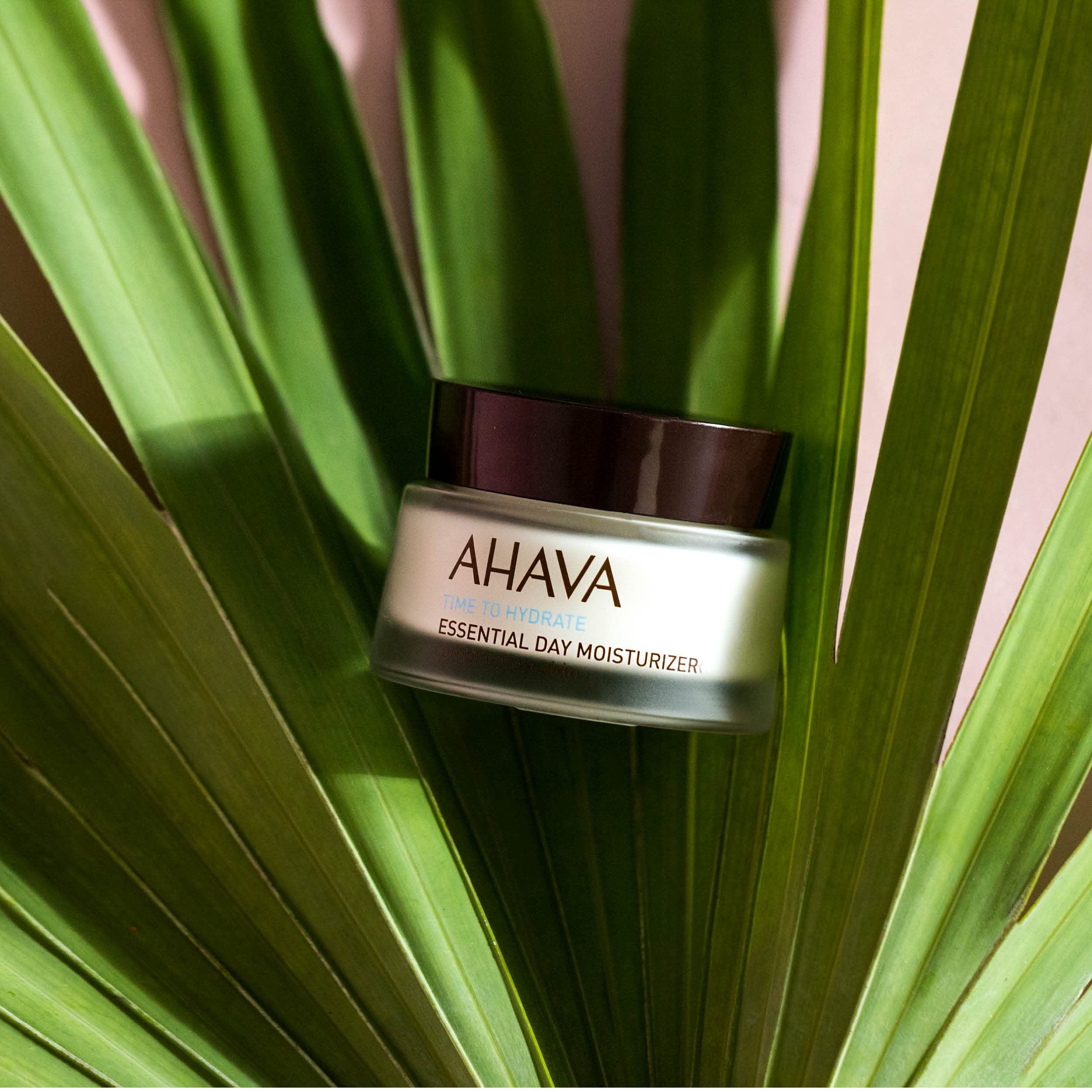 AHAVA Essential Day Moisturizer packaging on shelf for easy shopping.