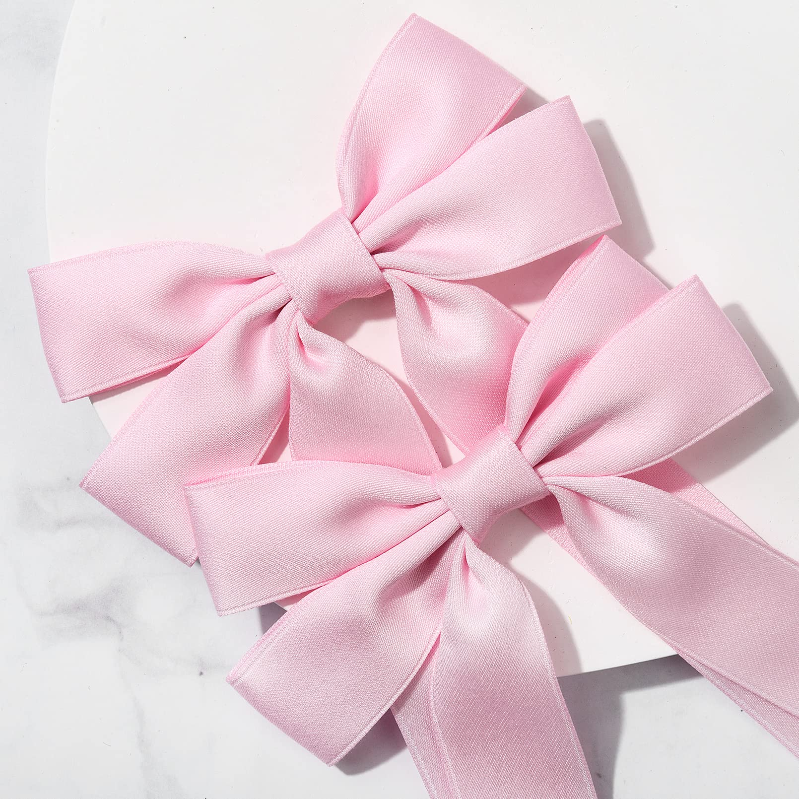 Aileam pink bow with sturdy alligator clip for reliable hair styling.