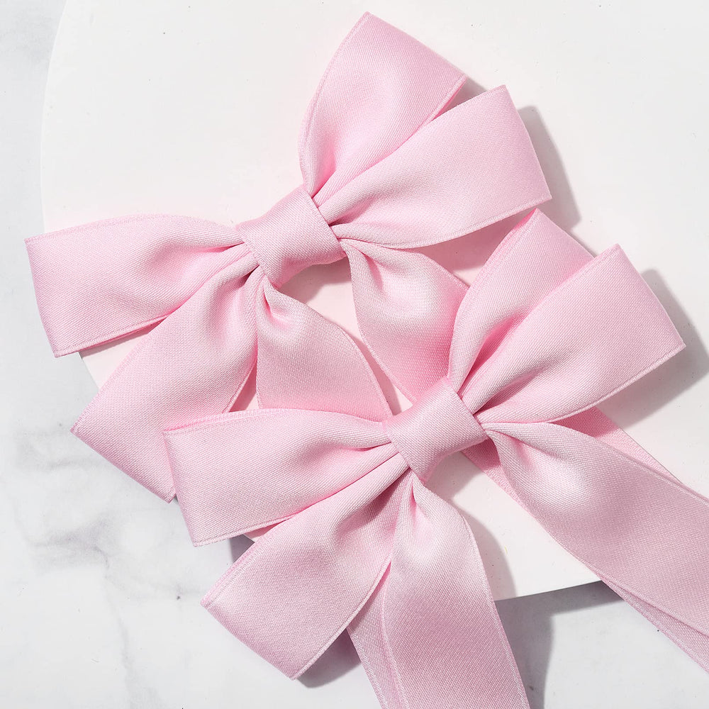 Aileam pink bow with sturdy alligator clip for reliable hair styling.