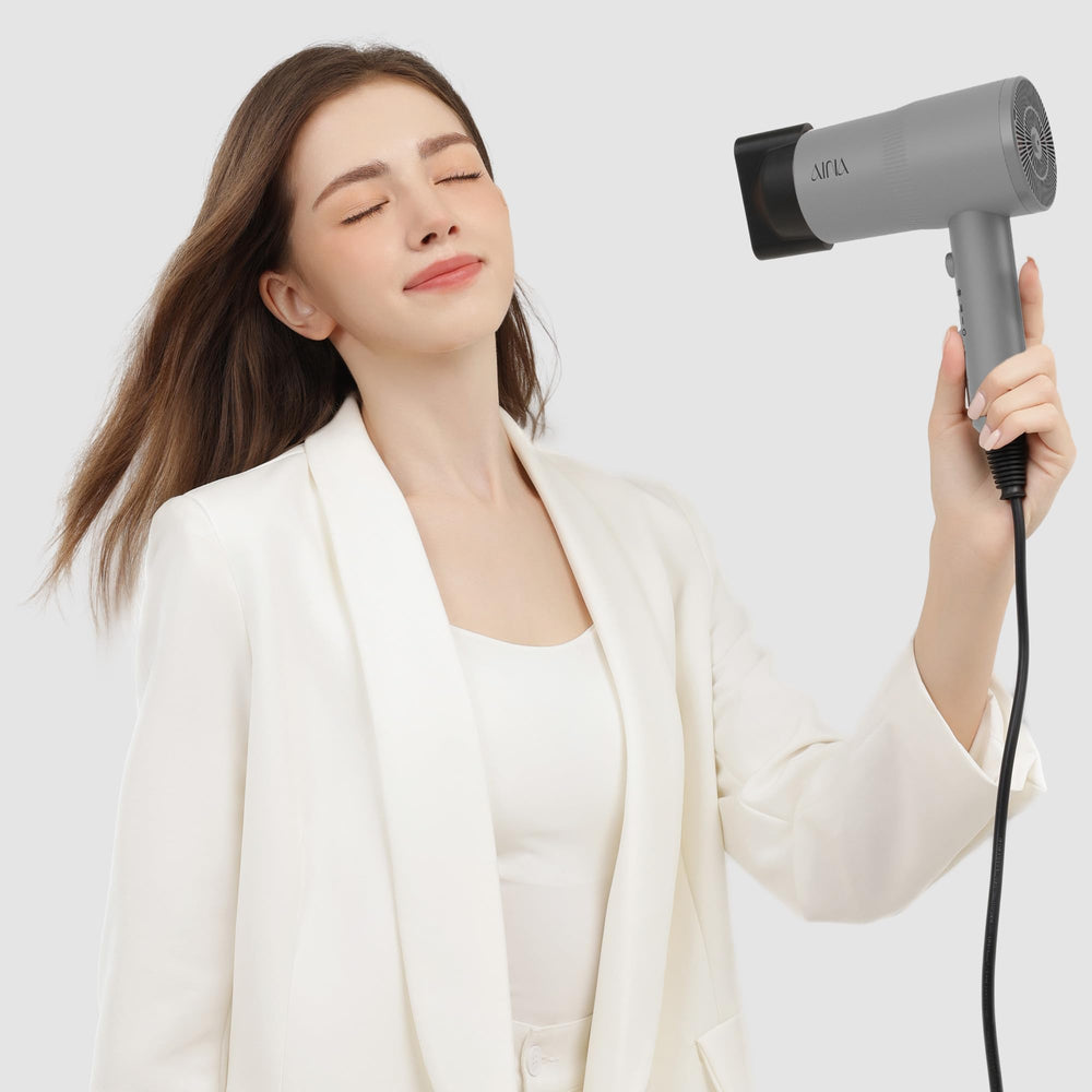 AINA hair dryer cold shot button for locking in style with cool air