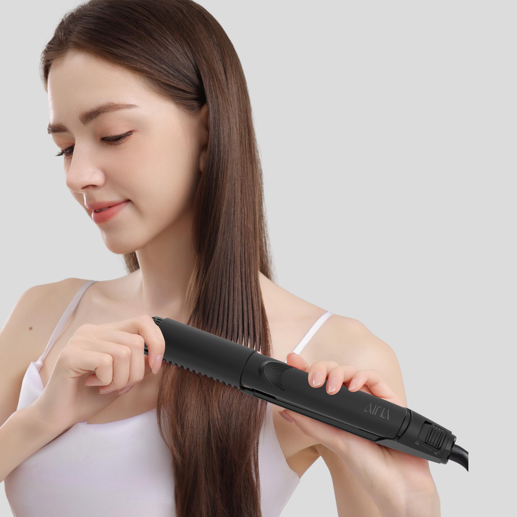 AINA Hair Straightener Comb in hand styling tangles and frizz possibilities.