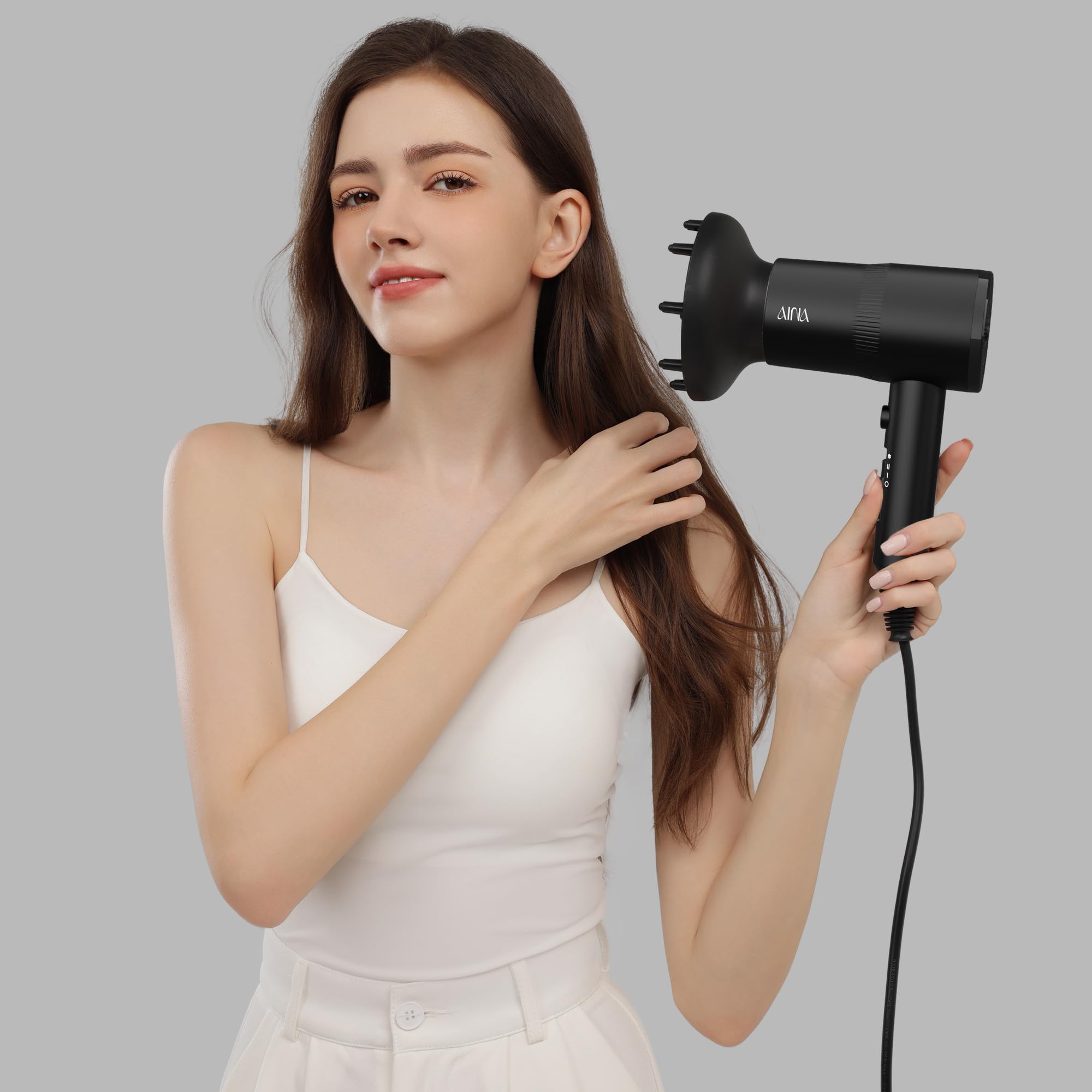 AINA volumizing diffuser for root lift and balanced styling.