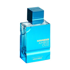 Al Haramain Amber Oud Aqua Dubai cap close-up highlighting luxury scent.