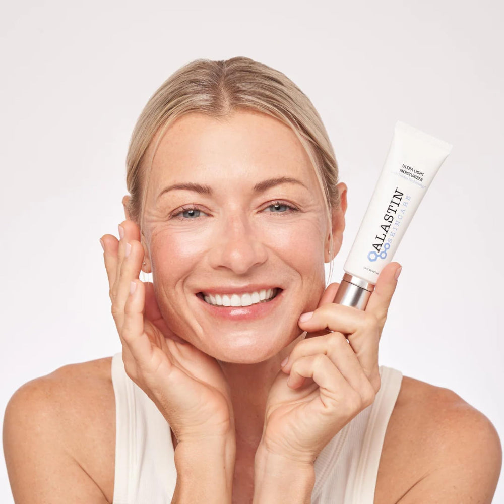 ALASTIN moisturizer being applied, suggesting soothing, lightweight hydration during morning routine