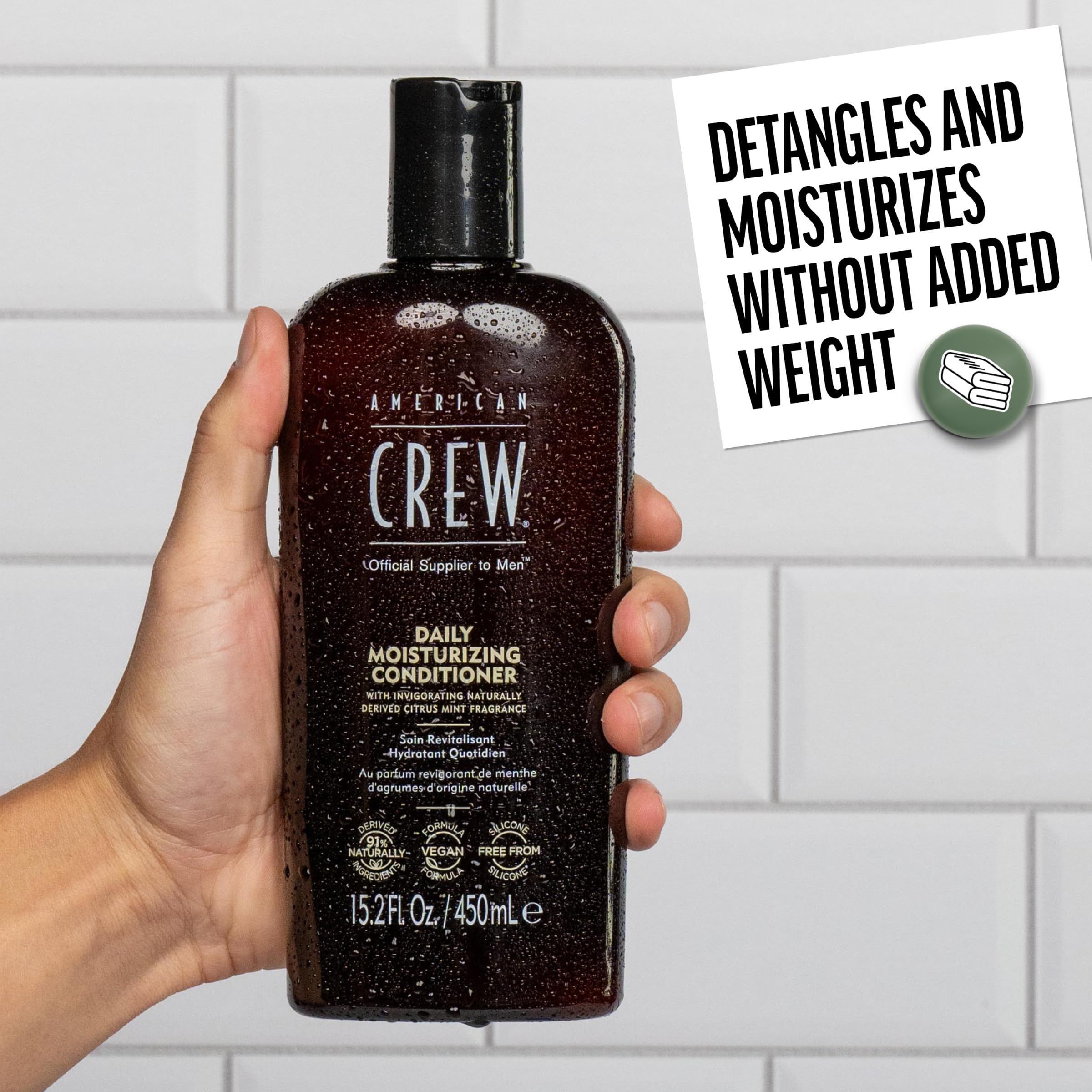 American Crew Daily Moisturizing Conditioner being applied to hair.