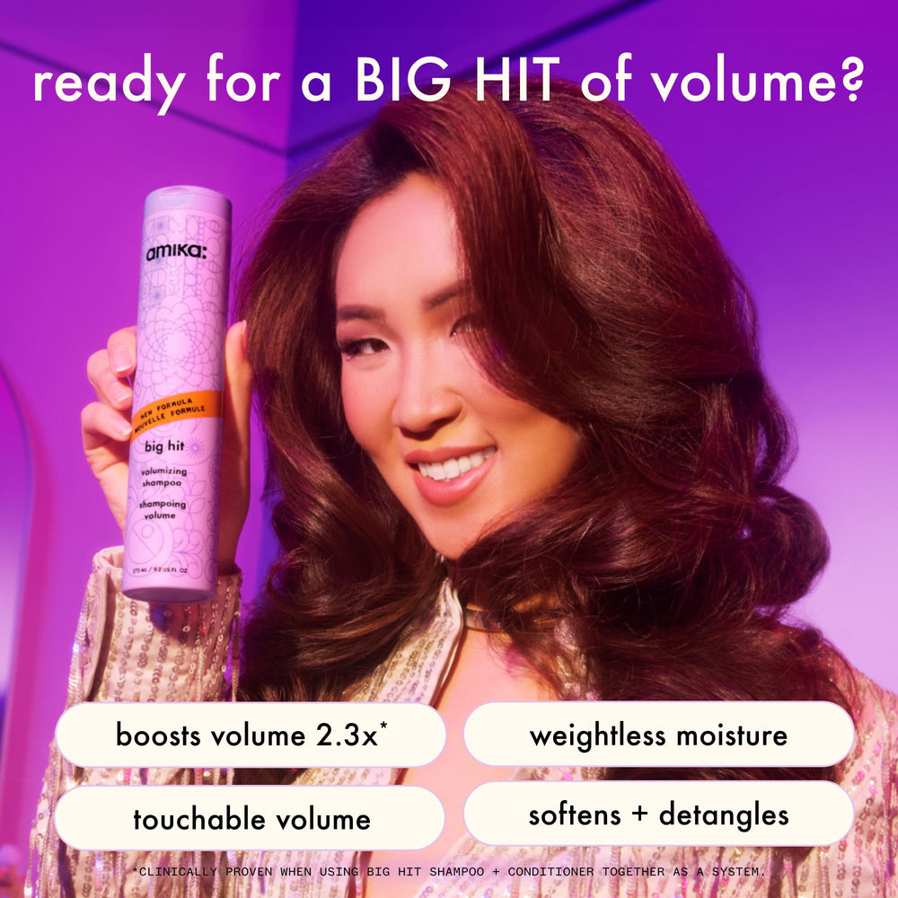 Amika Big Hit conditioner being poured into hand for easy application.