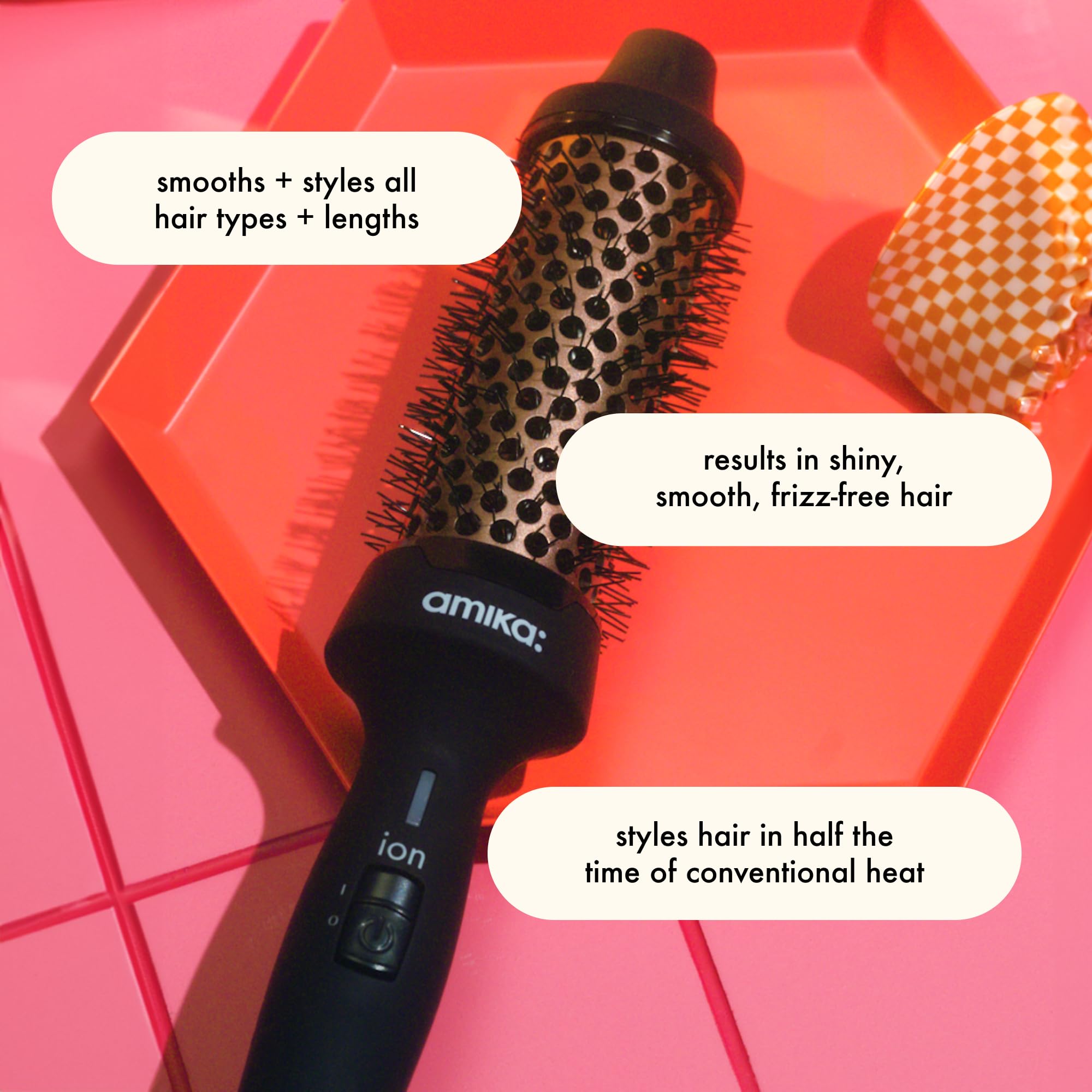 Amika Blowout Babe thermal brush smoothing action reduces frizz for sleek day-long styles.