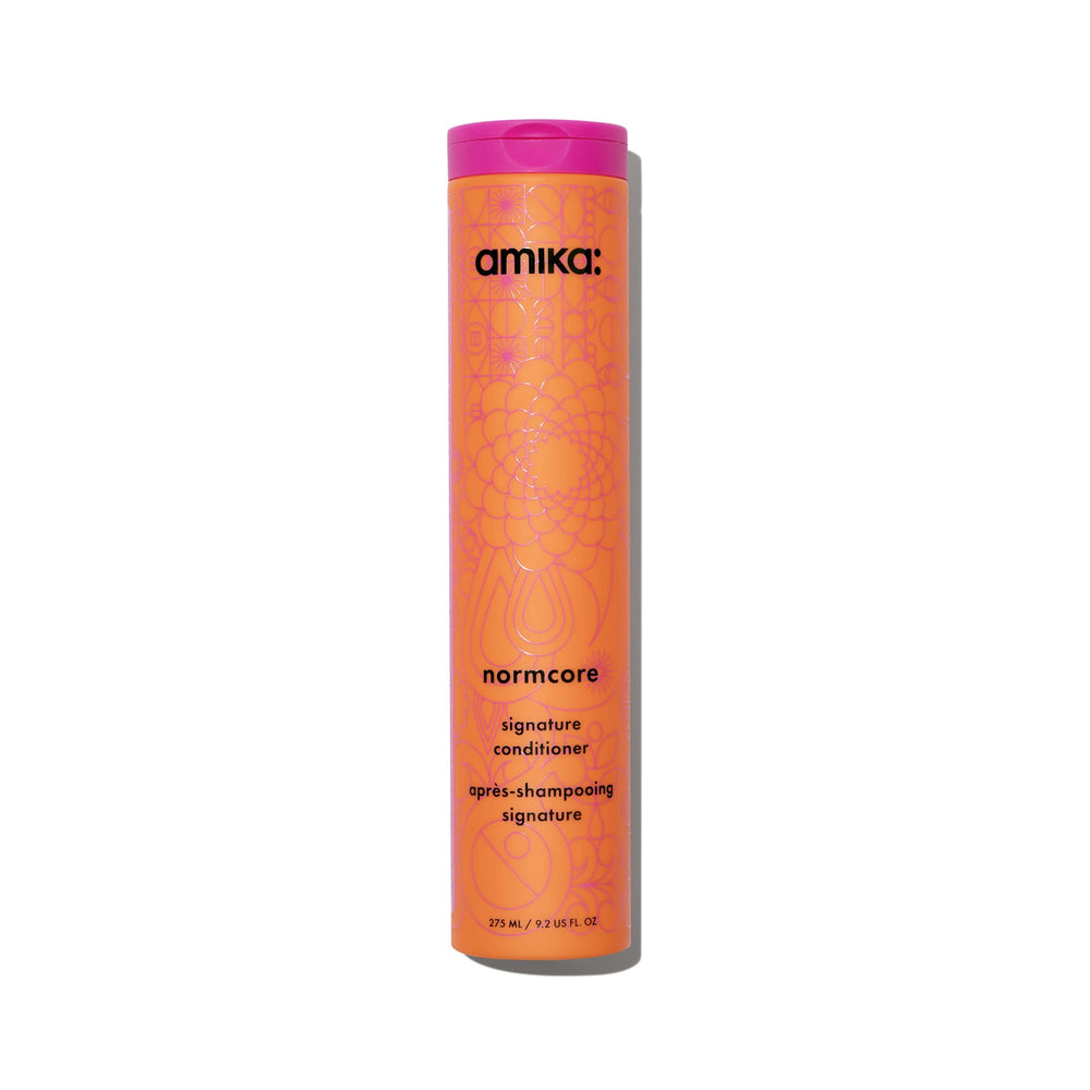 amika Normcore Signature Conditioner bottle front, showcasing hydrated, soft hair appeal