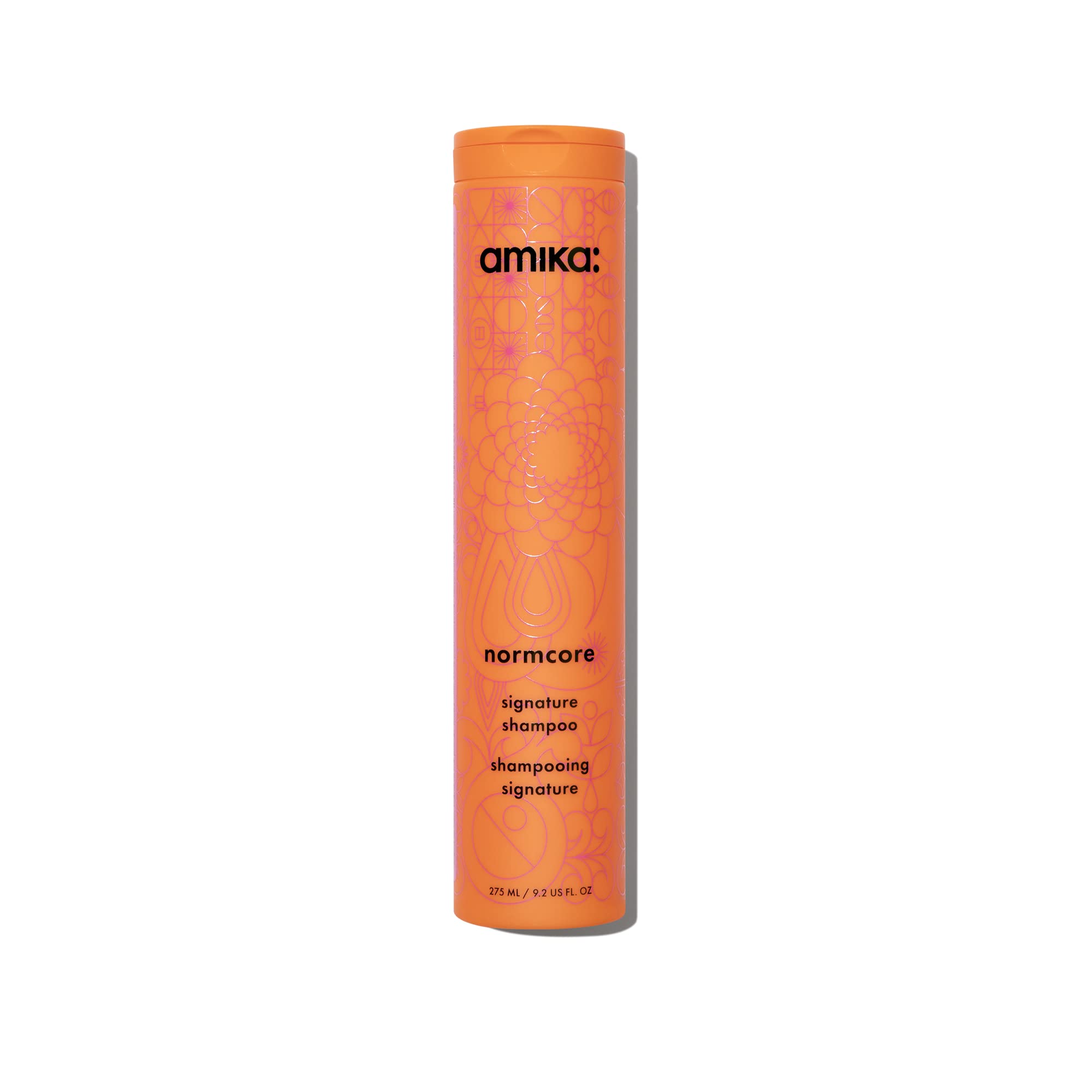 Amika Normcore Signature Shampoo bottle pour showing gentle daily cleanse and hydration