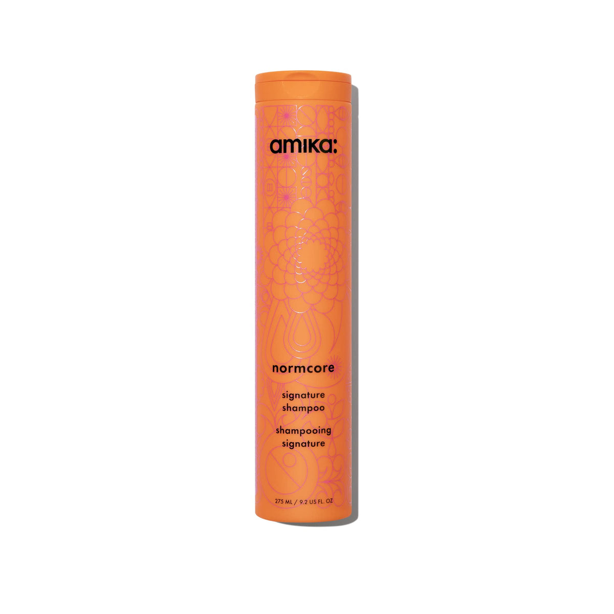Amika Normcore Signature Shampoo bottle pour showing gentle daily cleanse and hydration