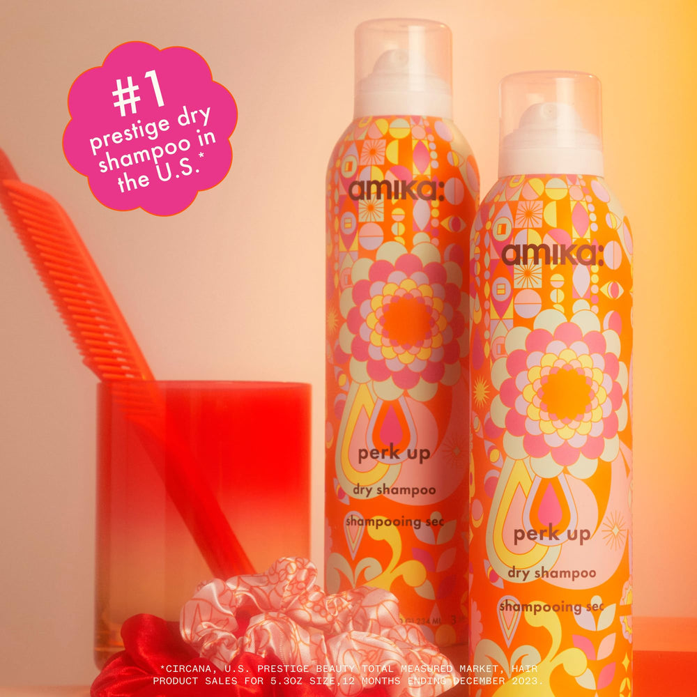 Amika Perk Up Dry Shampoo mist being sprayed on roots