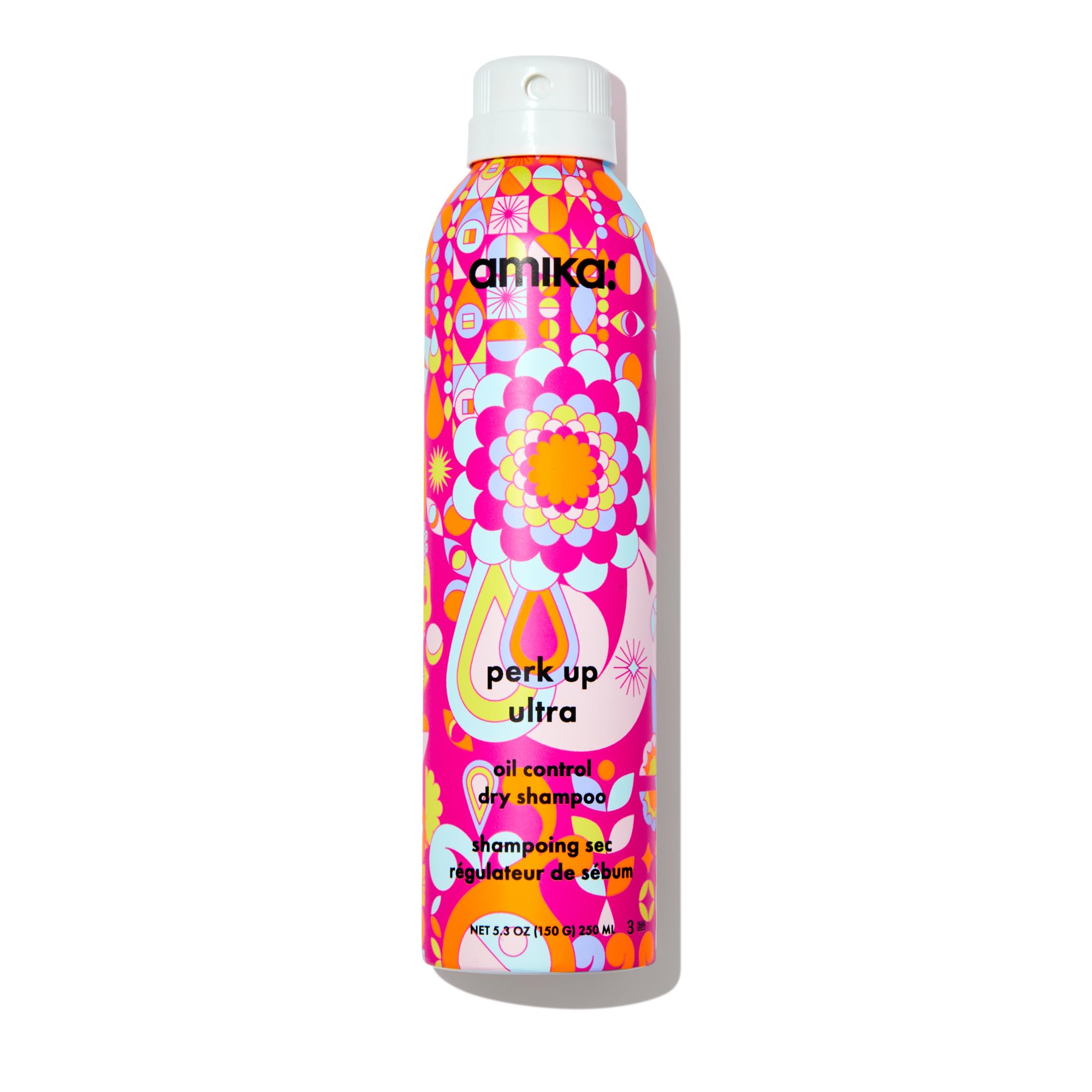 Amika Perk Up Ultra Dry Shampoo bottle on a bathroom counter for oil-control refresh.