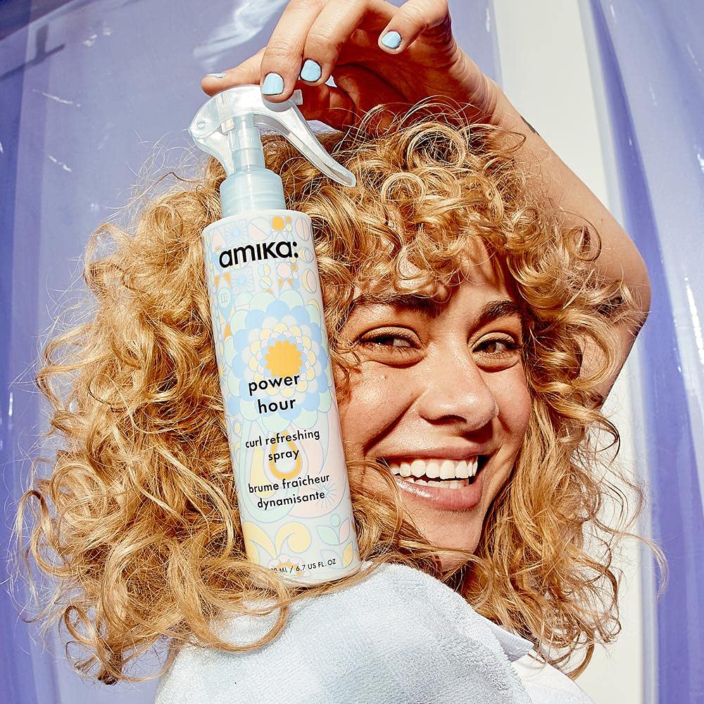 Frizz-control spray on frizz-prone strands for smooth look